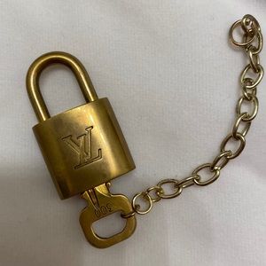 Authentic Louis Vuitton lock with key.
